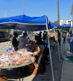FoodCycle LA distribution booth with bread and bakery items.